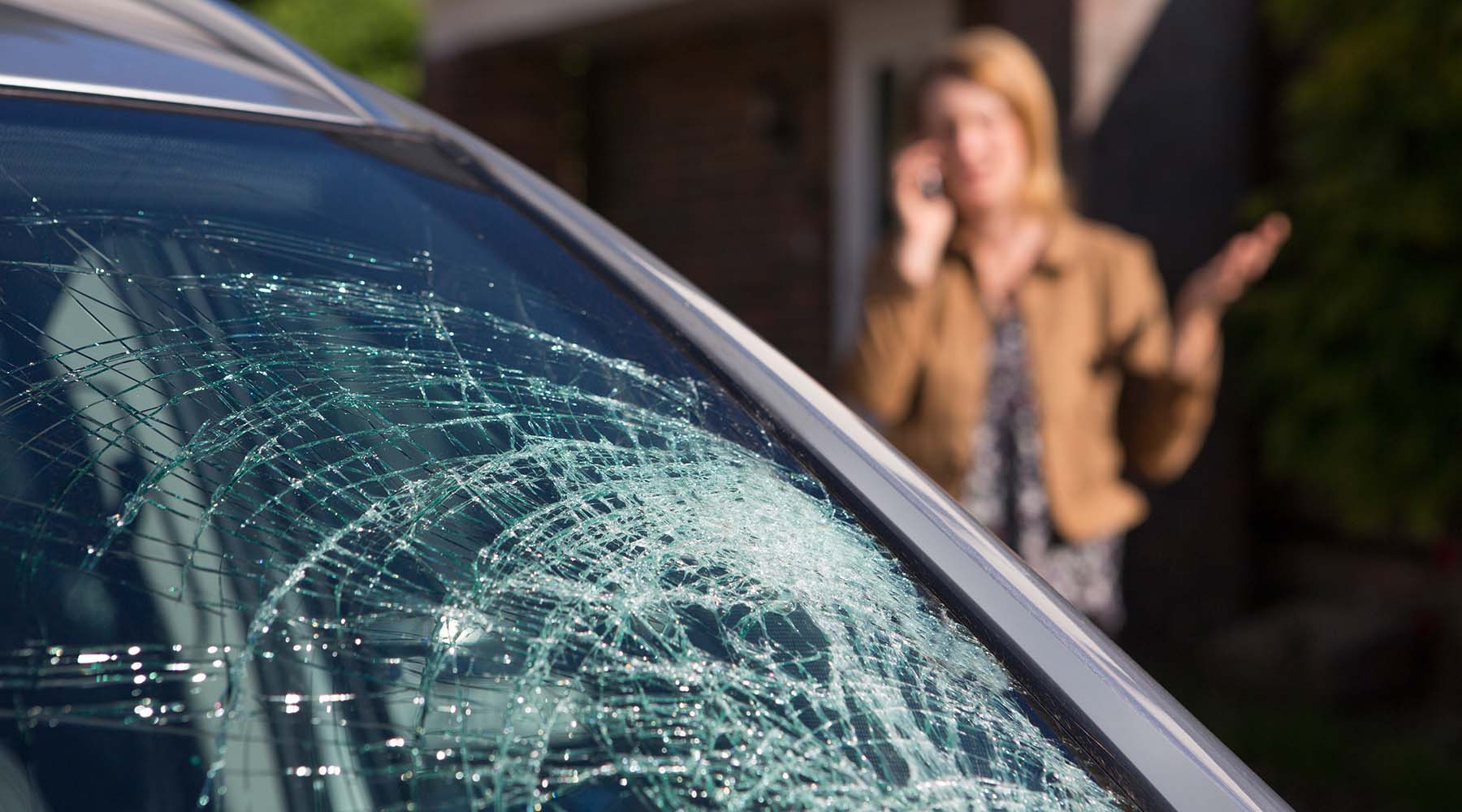 Woman with cracked windshield calling for replacement - Fastglass Dallas